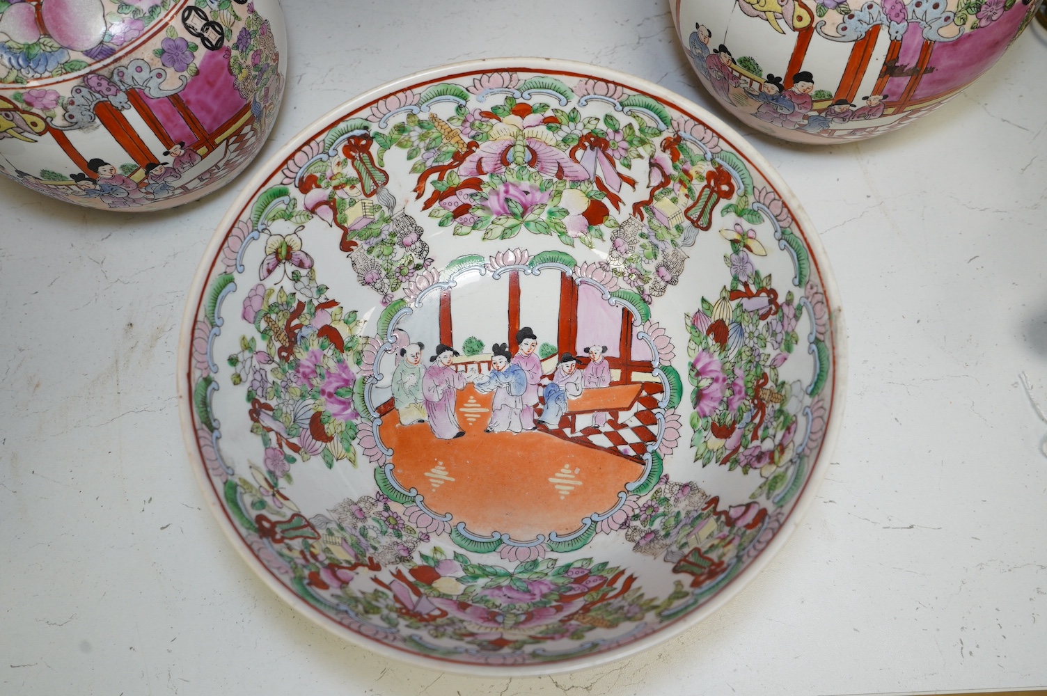 A 20th century Chinese famille rose bowl and a pair of jars and covers, bowl 26cm diameter. Condition - good